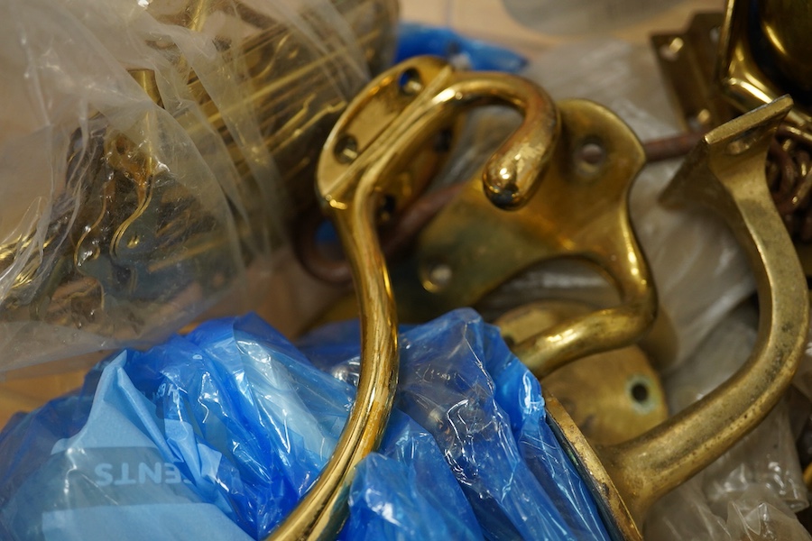 A collection of brass fittings to include lions-head door-knocker and various handles and hinges. Condition - varies